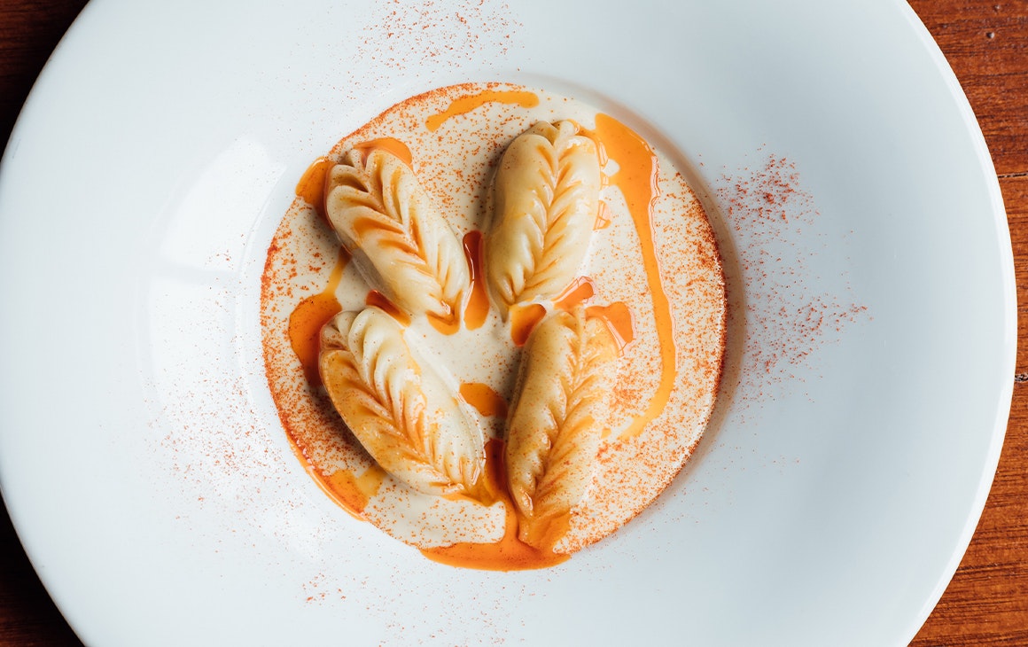 a bowl of filled pasta in sauce